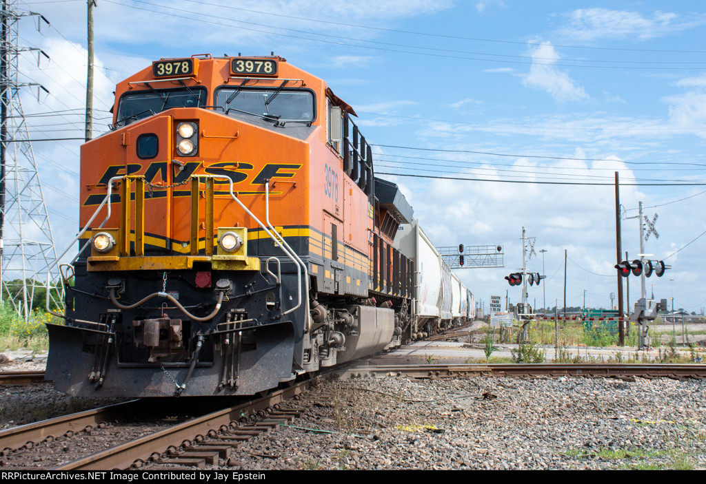 A BNSF train pounds the diamonds at T&NO Junction